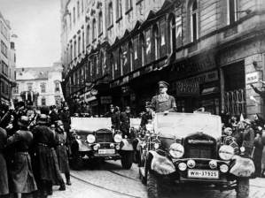 A victorious Hitler parades in just-occupied Prague: “painful sacrifices” hardly sated his appetites