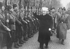 Husseini giving the “Heil Hitler” Salute to Bosnian Muslim volunteers to the notorious Waffen SS Handzar Division in November 1943.